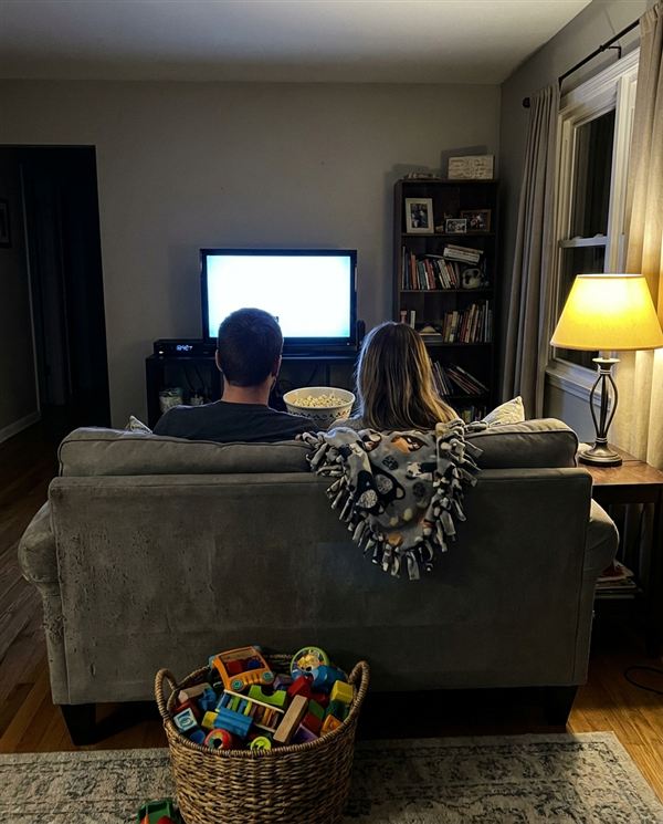 Couple watching a movie together on the couch